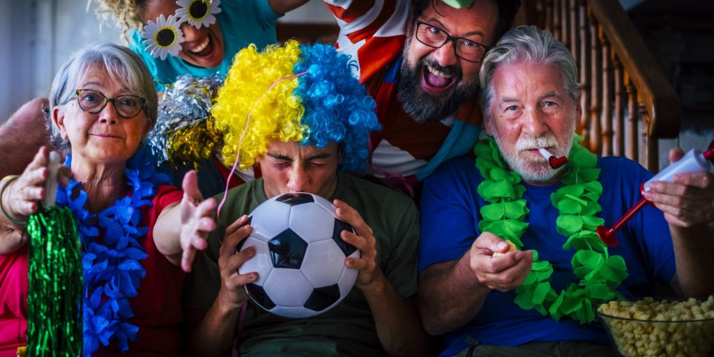 Group of football fans at home enjoy and exult for team success - world championship